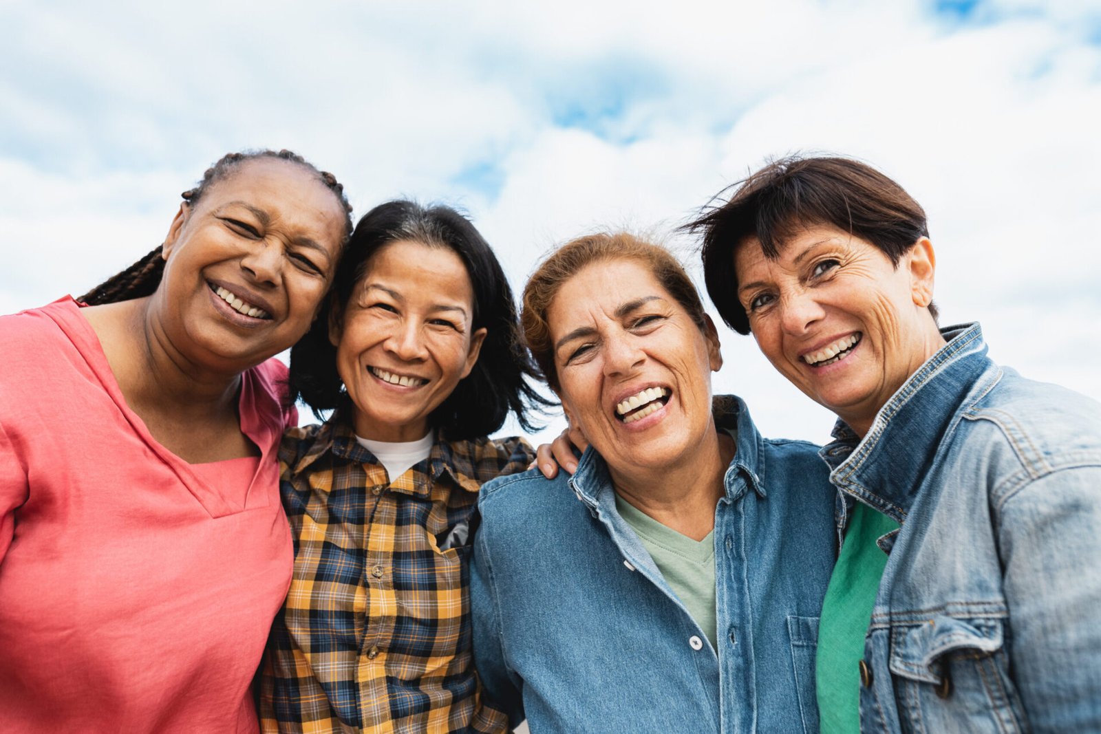 Happy multiracial senior women having fun smiling into the camer